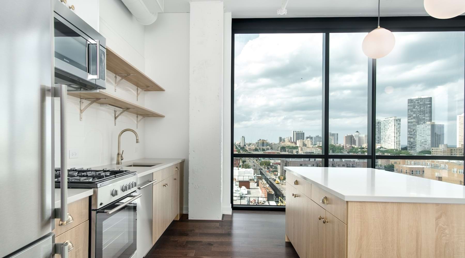 kitchen showing an island, bright lighting and modern appliances