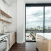 kitchen showing an island, bright lighting and modern appliances