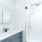 luxury bathroom with glass enclosed rain shower at The Draper apartments in Uptown Chicago