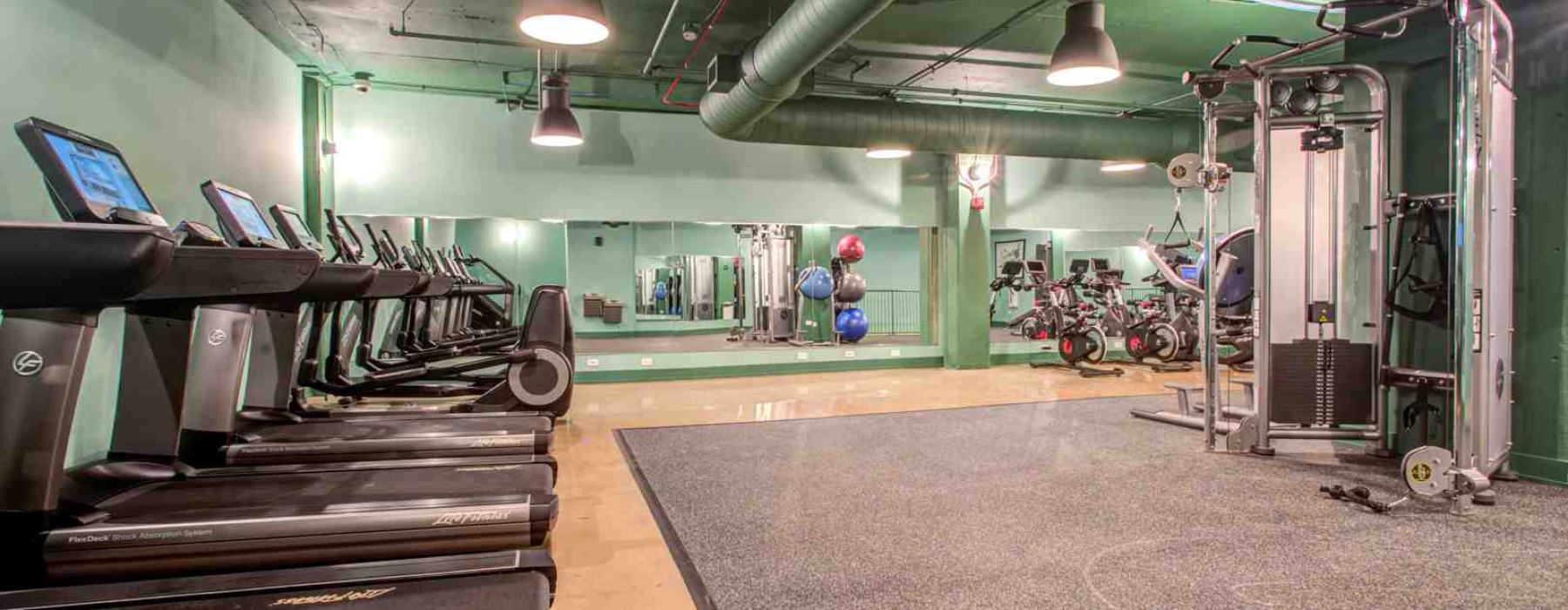 fitness focused uptown apartments modern gym floor-to-ceiling windows